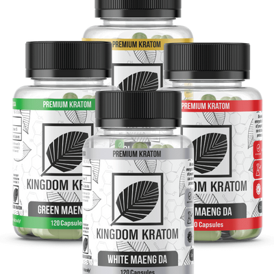 Four bottles of Kingdom Kratom capsules, each labeled with a different strain name: Green Maeng Da, Red Maeng Da, White Maeng Da, and Yellow Maeng Da.